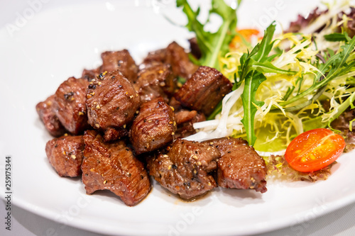Fried sauteed beef tenderlion cubes with black pepper photo