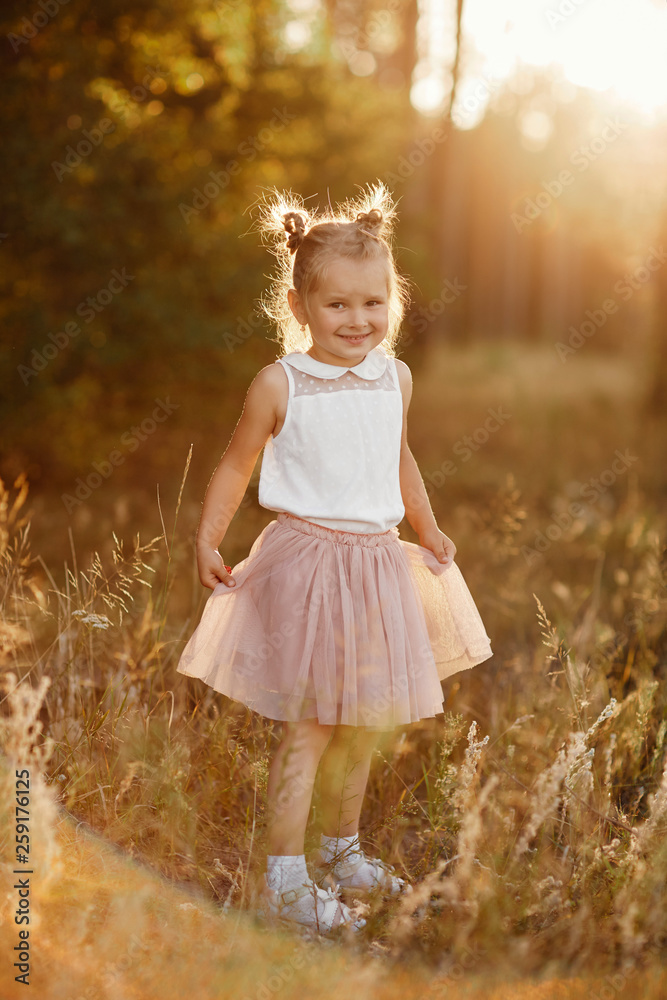 children's portrait of a girl. beautiful girl at sunset children's portrait of a girl. beautiful girl at sunset
