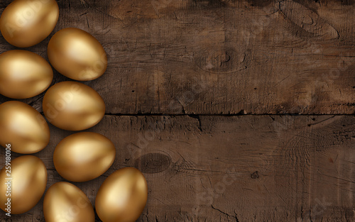 Gold Easter eggs on dark wooden background. Rustic dark background. Colorful golden easter eggs on a wooden table. Invitation template design, place for text, decoration, greeting card