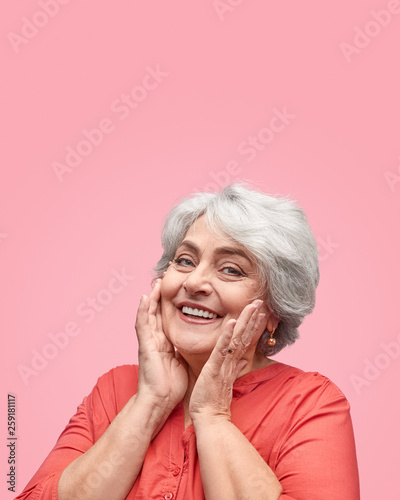Pleased senior lady looking at camera