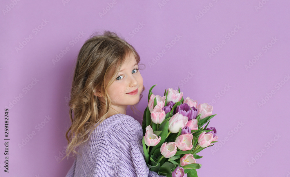 Beautiful girl with flowers tulips in hands on a light background. Beautiful girl with flowers tulips in hands on a light background.