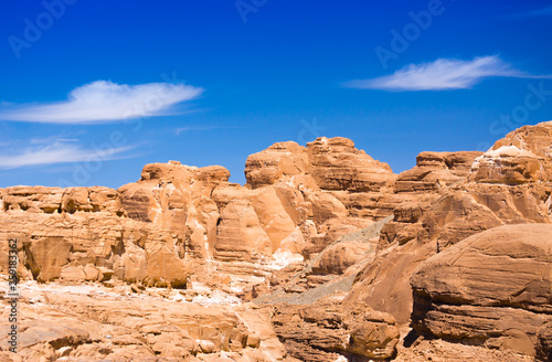 peaks of high stone rocks against a blue sky in Egypt Dahab South Sinai