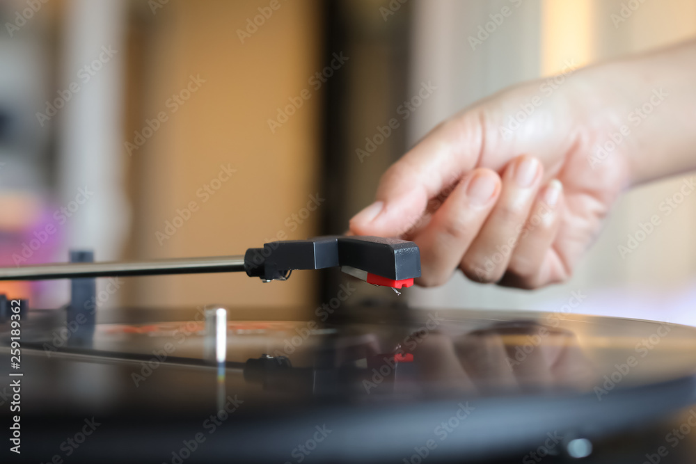 Hand holding record player stylus Hand holding record player stylus