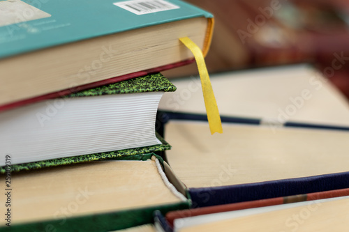 Stack of varied books many books piles