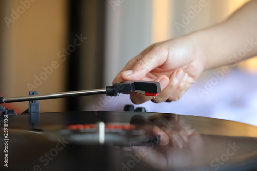 Hand holding record player stylus