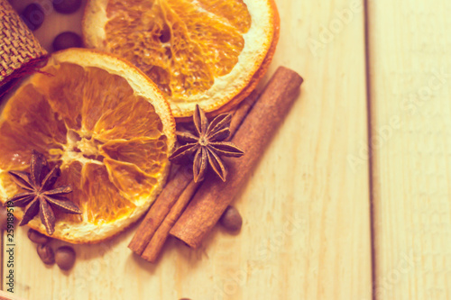 Dried orange and cinnamon on wooden background.