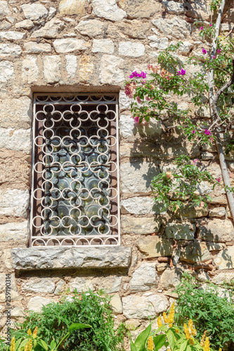 Window in a wall of a medieval house in the French village of Eze