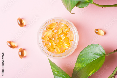 Fish oil capsules (omega-3) on a pink background photo