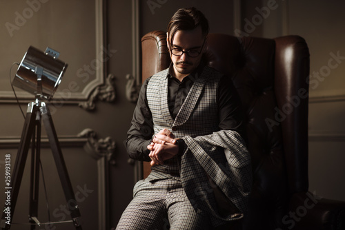 Tablou pe pânză Young handsome man posing for a fashion shoot in a studio