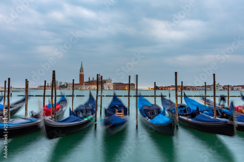 Gondolas moored in Piazza San Marco with San Giorgio Maggiore church in the background, Italy © Stefanos Kyriazis