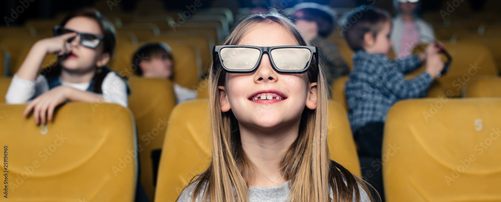 panoramic shot of smiling friends in 3d glasses watching movie together