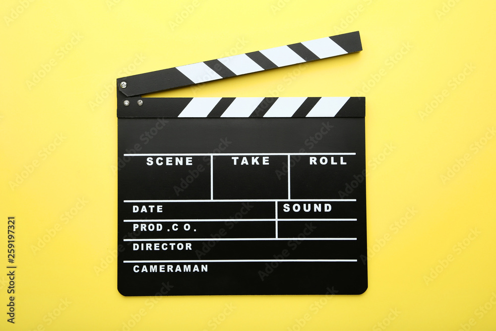 Clapper board on yellow background