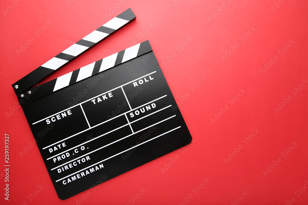 Clapper board on red background
