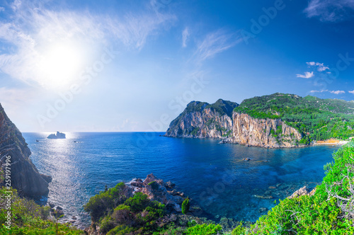 Fototapeta Naklejka Na Ścianę i Meble -  Beautiful summer panoramic seascape. View of Paleokastritsa famous beach in close bay with crystal clear azure water on Corfu island, Ionian archipelago, Greece.