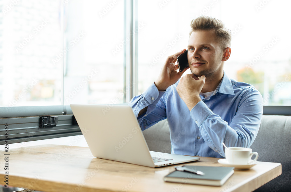 Stylish young man calling by the phone to solve business problems. Online consultation by phone. Freelancer discussing the development and planning of his online project. Outsourcing. Mobile services. Stylish young man calling by the phone to solve business problems. Online consultation by phone. Freelancer discussing the development and planning of his online project. Outsourcing. Mobile services.