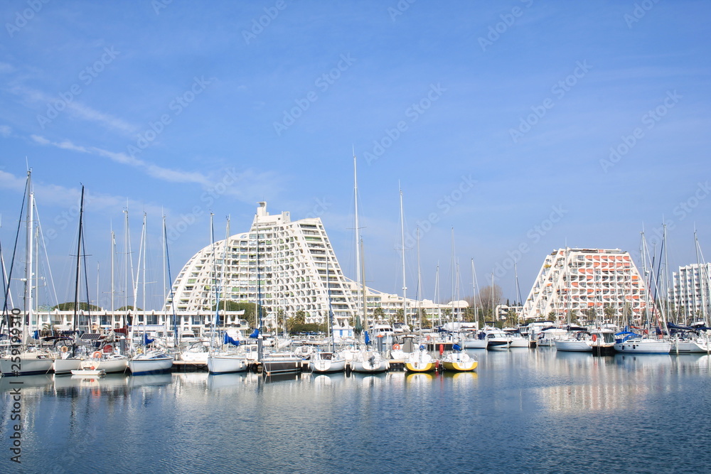 Pyramids buildings and pleasure boats in the seaside resort and marina  of la Grande Motte in Herault department, France