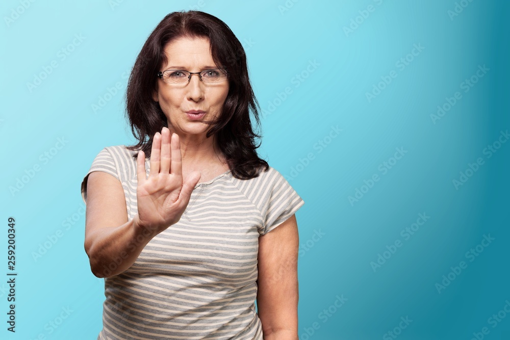 Middle-aged woman showing stop sign