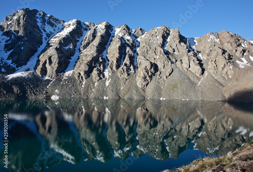 Mountains reflection on the lake surface, Alakol, Tian-Shan, Kyrgyzstan photo