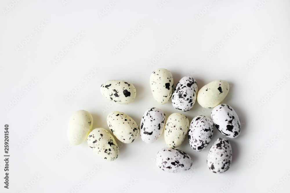 Quail eggs on white background. Eggs before painting for Easter. White egg. Speckled eggs