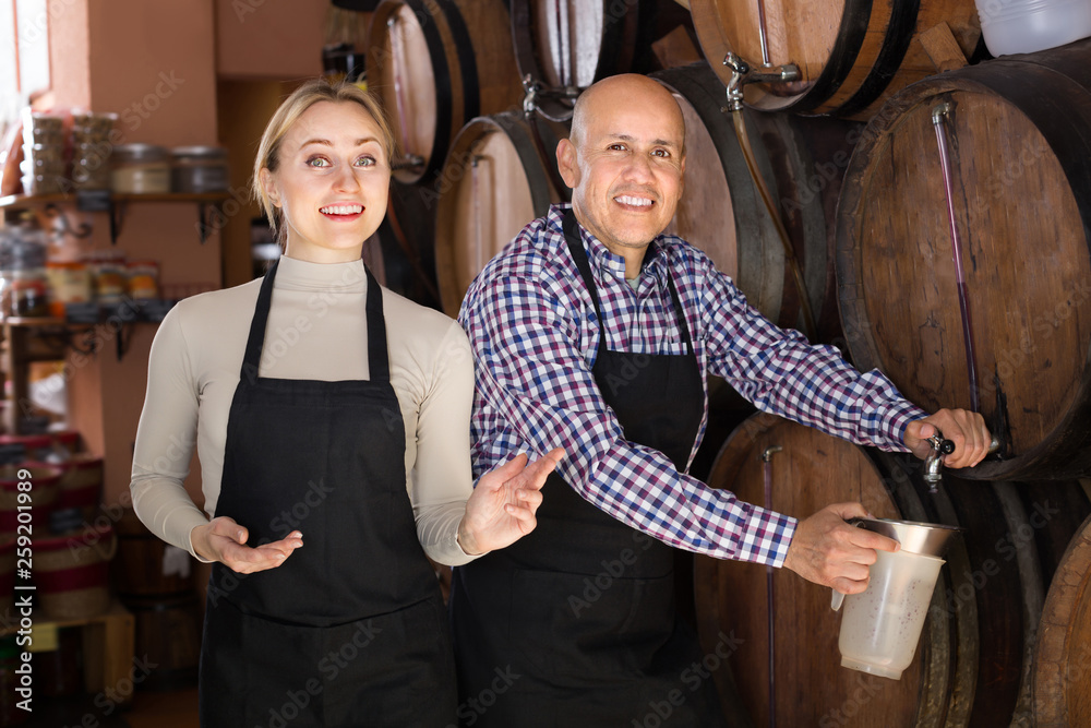 Portrait of two friendly wine makers taking wine