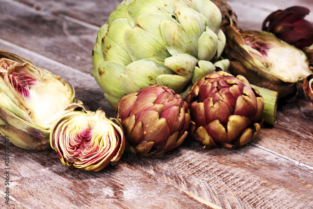 Obraz premium artichokes on grey background. fresh organic artichoke flower vegetable