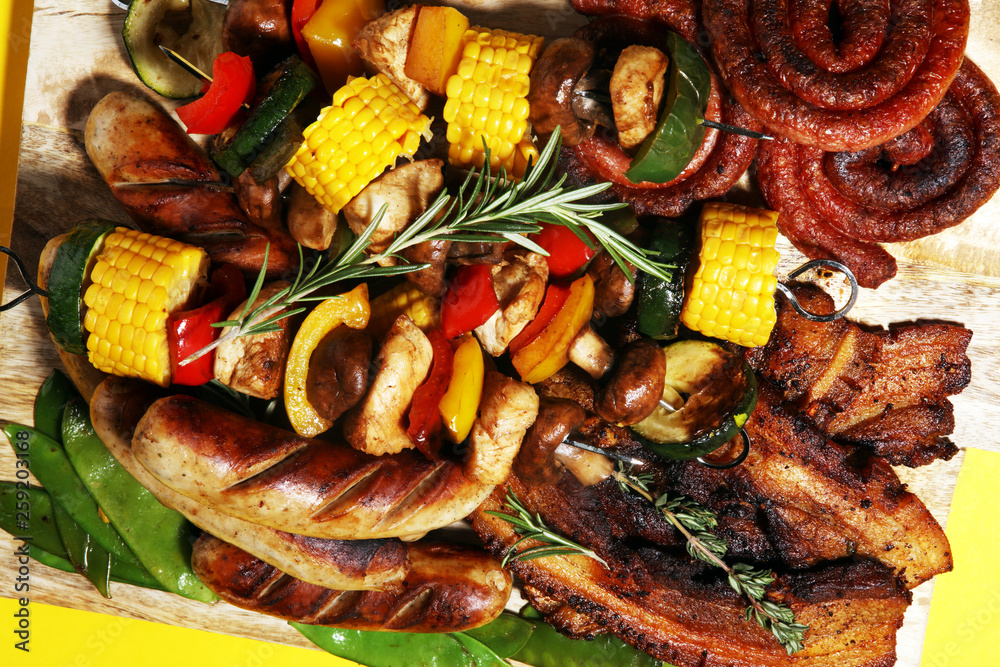 Assorted delicious grilled meat and skewer with vegetable on rustic table Assorted delicious grilled meat and skewer with vegetable on rustic table