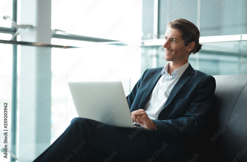 Young businessman working on a plan of Internet project on the laptop. Man discusses business matters by phone. Working computer for internet research. Digital marketing. Development Young businessman working on a plan of Internet project on the laptop. Man discusses business matters by phone. Working computer for internet research. Digital marketing. Development