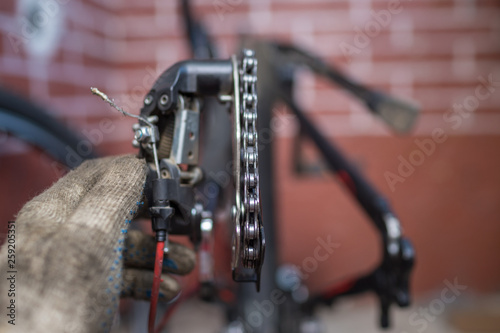 Bicycle mechanic in a workshop in the repair process 