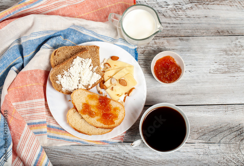 Healthy breakfast with feta cheese, a cup of coffee and sandwiches 