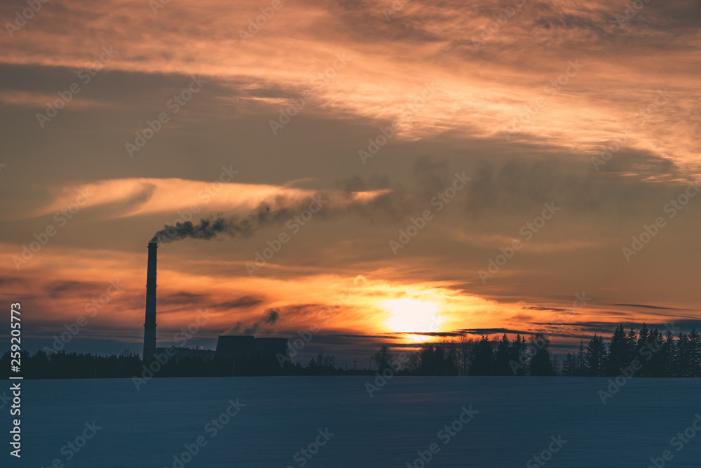 working thermal power plant on the background of a beautiful sunset