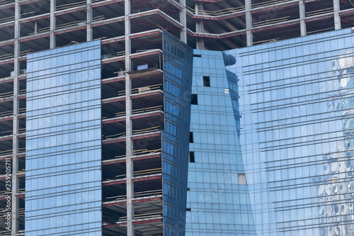 wall with window openings in a multi-storey high-rise residential building under construction from concrete and brick