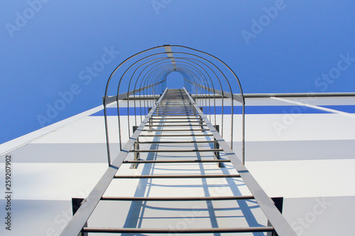 Metal ladder on the building. Emergency exit from the building