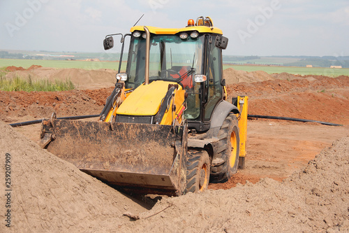 Loader moves the land on the construction site.