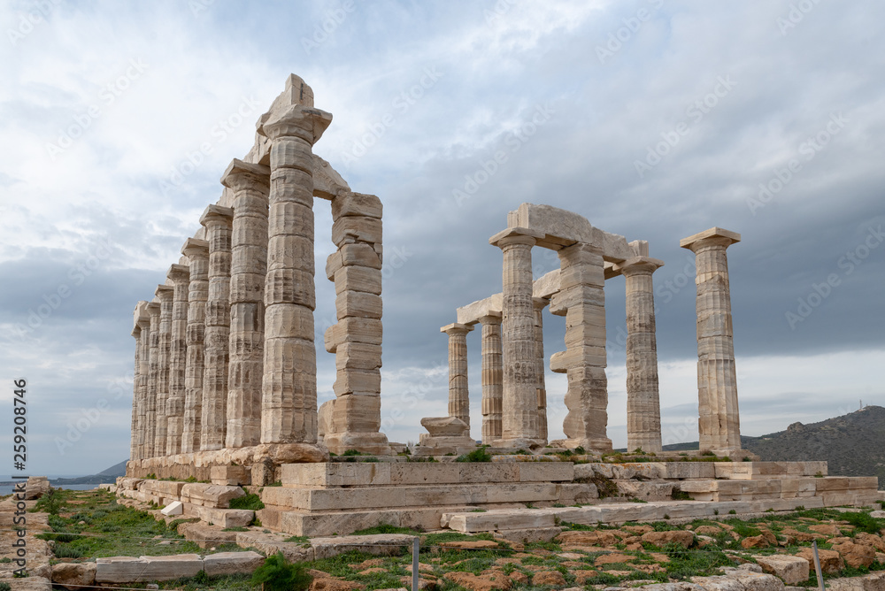 Greek temple columns clouds sky angle