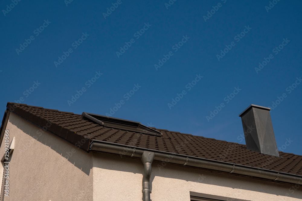 New building roof with roof window and chimney and gutter as well as text space New building roof with roof window and chimney and gutter as well as text space