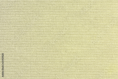 Abstract blank background for layouts. Thick yellow upholstery fabric closeup. Light photo.