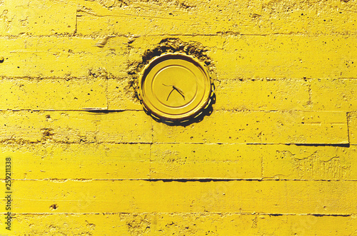 clock on the uellow wall photo