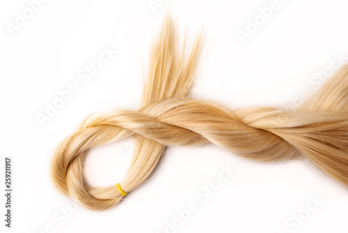 Light blond hair tress on white isolated background. Human, natural hairstyle with copy and free space. Floating border. Fashionable hairstyle for a poster, an advertisement or a hairdressing website.
