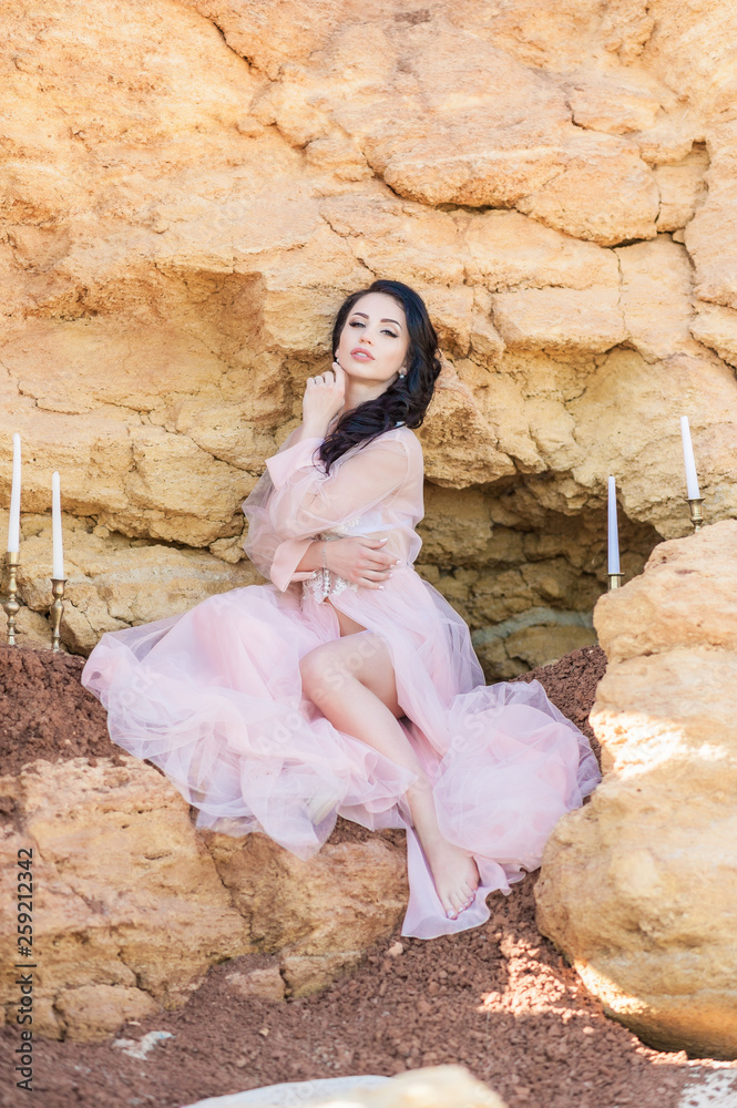 Romantic girl portrait of curly woman with long hair and bright makeup. Morning of the bride. Pink transparent peignoir. Lace. Portrait of sexy young lady in elegant boudoir posing with crossed hands, Romantic girl portrait of curly woman with long hair and bright makeup. Morning of the bride. Pink transparent peignoir. Lace. Portrait of sexy young lady in elegant boudoir posing with crossed hands,