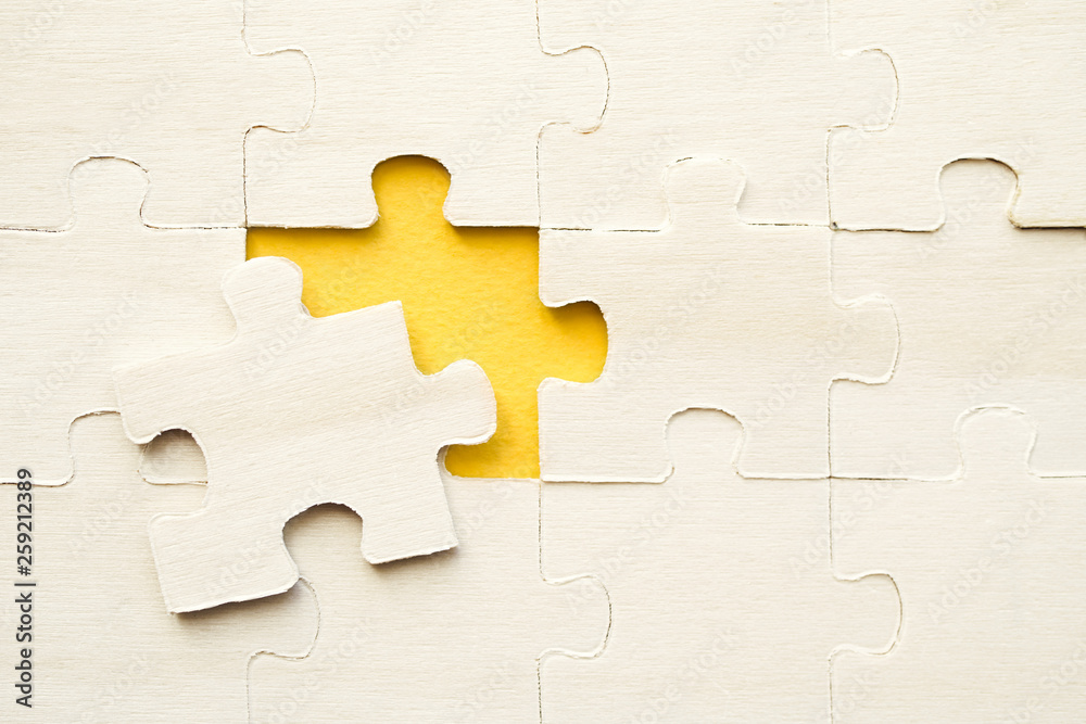 Wooden puzzles on a yellow background, closeup, top view Wooden puzzles on a yellow background, closeup, top view