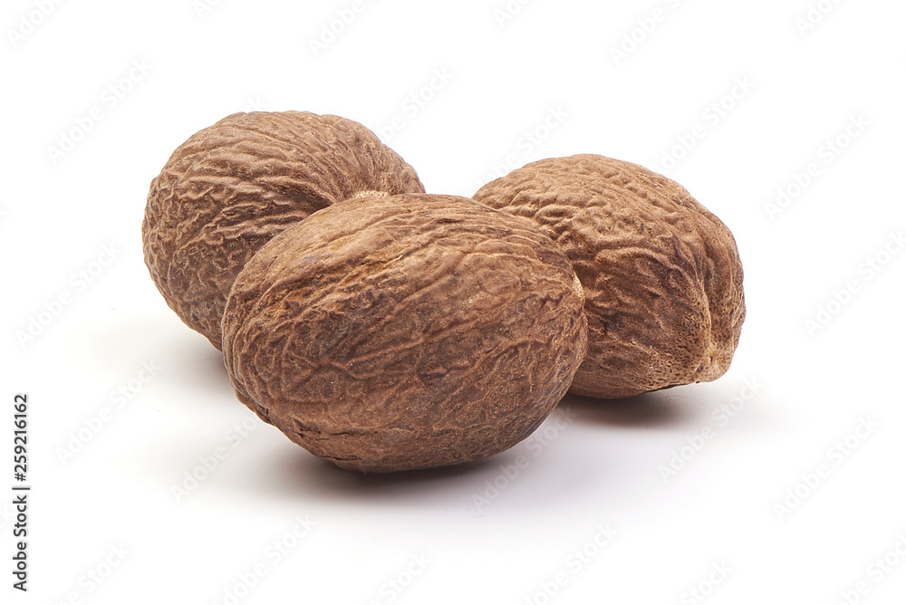 Fresh Nutmeg. Whole nuts, close-up, isolated on white background Fresh Nutmeg. Whole nuts, close-up, isolated on white background
