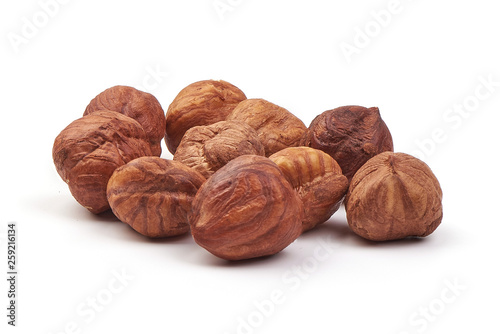 Peeled hazelnuts, close-up, isolated on white background