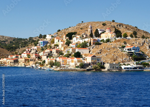 Colorful architecture of the buildings of the rocky shore of the island Symi. © delobol
