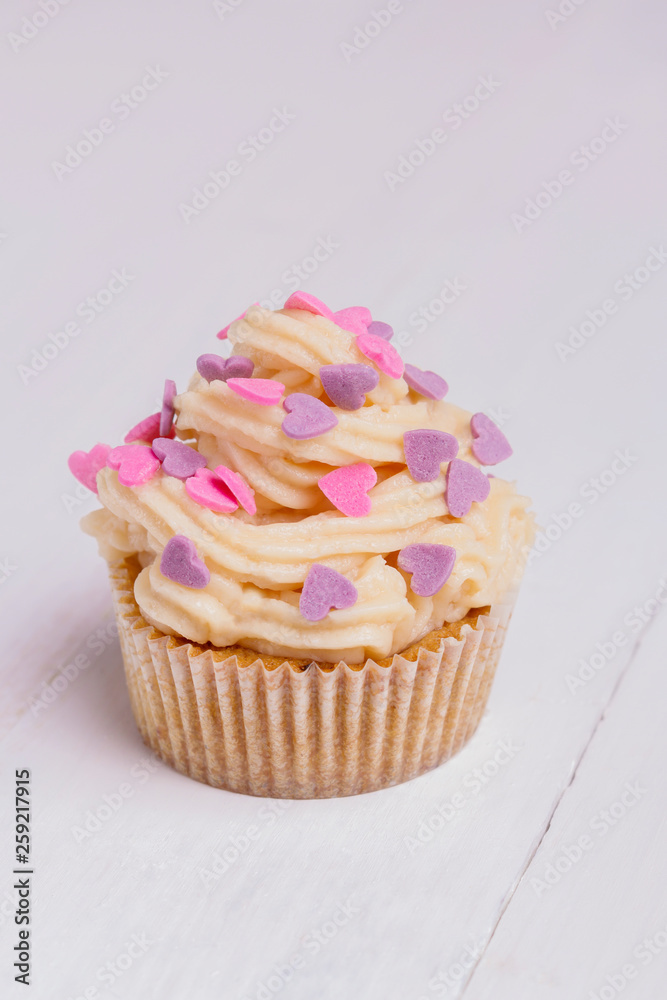 Delicious cupcake on white wooden table close-up Delicious cupcake on white wooden table close-up