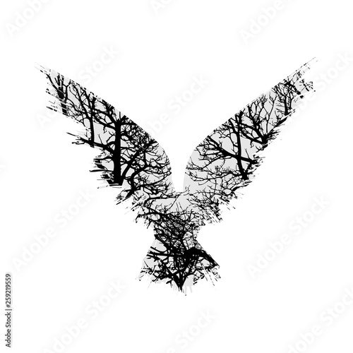Gray raven silhouette with black trees isolated on white background