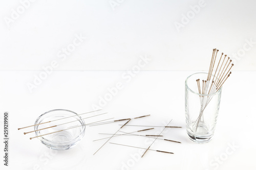 Silver needles for traditional Chinese acupuncture medicine. White background.