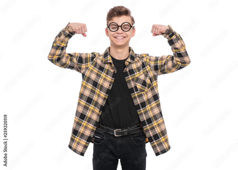 Portrait of caucasian teen boy in funny eyeglasses, isolated on white background. Funny teenager wearing plaid shirt showing off his biceps. Handsome child showing his hand biceps muscles strength. Portrait of caucasian teen boy in funny eyeglasses, isolated on white background. Funny teenager wearing plaid shirt showing off his biceps. Handsome child showing his hand biceps muscles strength.