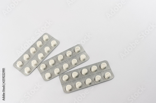Strips with white pills in blister pack isolated on a white back ground