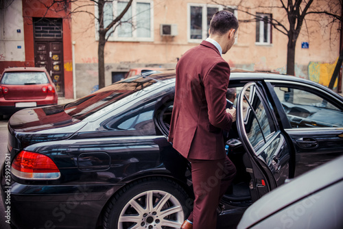 Suit man enters in a business limo © qunica.com