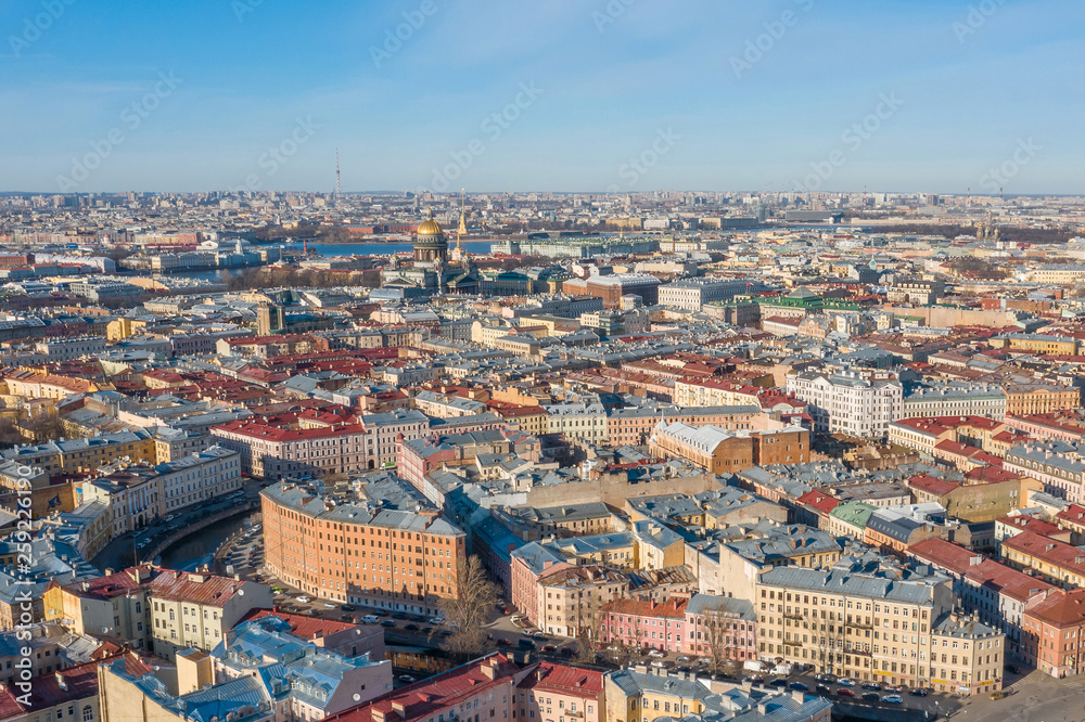 Aerial view roofs of old houses in the center of St. Petersburg, in the distance St. Isaac's Cathedral, Peter-Pavel's Fortress.